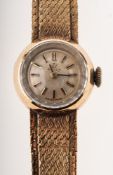 Omega a 9K gold wristwatch the round silvered dial having raised gilt and black baton numerals,