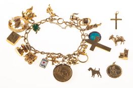A charm bracelet with charms and some loose charms,