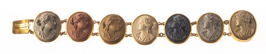 A Victorian gilt lava cameo bracelet, collet set with seven oval carved lava stones,