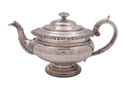 A George IV silver tea pot, of squat circular form, with a foliate scroll and shell border,