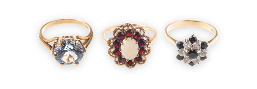 Three dress rings of varied design,