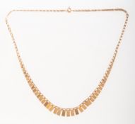 A fringe necklace, a 'paperclip' style chain with a centred graduated fringe design,