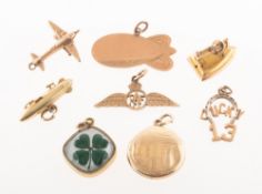 A mixed collection of eight charms, including a four leaf clover crystal charm, marked 14k,
