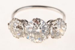 An impressive early 20th century three stone diamond ring,
