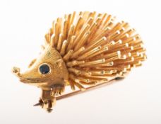 A 1960's 18ct gold and sapphire hedgehog brooch, collet set with two circular-cut sapphires as eyes,