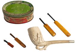 An early 20th century football themed clay pipe, together with three miniature cricket bats,
