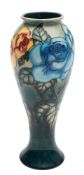 A John Moorcroft limited edition pottery vase tube lined in the Rose and Bud pattern
