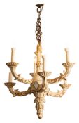 A carved and cream painted wood six light chandelier,