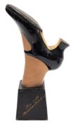 An early 20th century papier-mâché and painted countertop 'Sure Grip Stick-on Rubber Soles'