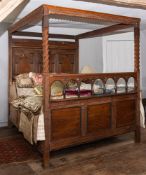 A George III carved oak tester bed,