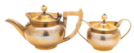 A late Victorian silver-gilt bachelor's tea pot & matching sugar bowl & cover, squat circular form,