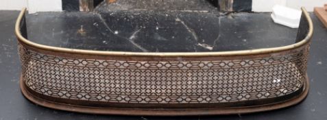 A Regency brass and cut steel fender, early 19th century; of 'D' section and openwork form,