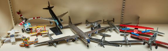 A collection of various toy and model aeroplanes, including a Hubley diecast Curtiss Tomahawk,