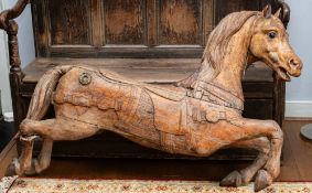 A carved hardwood carousel style horse, inset glass eyes,