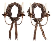 A pair of wrought iron twin light wall appliques,