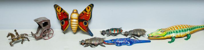 Three various clockwork tin plate horse and cart toys, a later clockwork dog cart, etc.