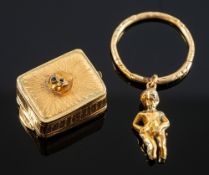 An item of interest, a musical box with a male nude figure atop attached to a carved split ring,