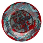 A Poole pottery studio ware charger with abstract blue decoration on a red ground, 35cm diameter,