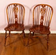 A set of four elm and oak hoop backed kitchen chairs, in George III style,