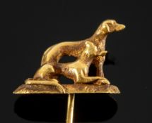 A dog stick pin, sat atop the pin is a standing dog, with a seated dog beside it,