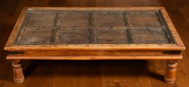 An Indian teak and wrought iron mounted coffee table,