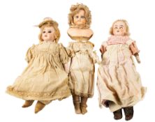An early 20th century bisque head doll, blonde wig, brown glass sleeping eyes,