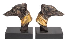 A pair of patinated and polished metal models of hounds' heads, probably bookends,