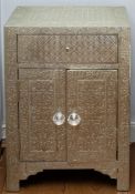 A pair of Indian repousse metal covered bedside cupboards,
