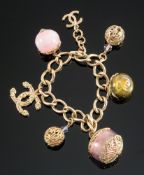 Chanel, a Chanel costume jewellery charm bracelet with charms including the 'CC' logo,