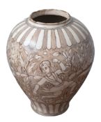 A Qajar pottery oviform jar decorated in muted tones of brown with figures, a deer,