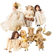 A group of seven late 19th/early 20th century miniature bisque head dolls,