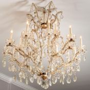 A gilt metal and moulded and cut glass eighteen light basket chandelier in Louis XV taste