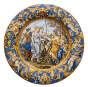 A Castelli maiolica charger profusely decorated with figures and a putto in a landscape