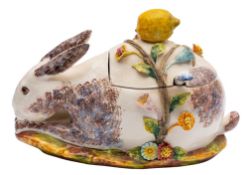A Continental pottery tureen cover and ladle, in the form of a grazing rabbit,
