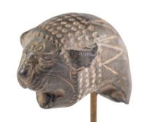AN ACHAEMENID BLACK STONE LION HEAD, CIRCA 5TH-4TH CENTURY B.C., finely detailed, 2.5cm.