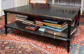An ebonised wood two-tier low table, modern; the top with ogee moulded edges,