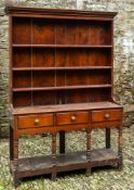 An oak and stained wood kitchen dresser, the base section early 19th century,