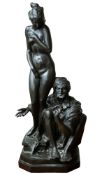A 'bronzed' resin group of a Moor and a female nude, in the manner of 19th century work by Bergmann,