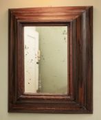 A rectangular rosewood cushion framed wall mirror, in Queen Anne style,