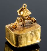 An item of interest, a musical box fob charm, carved decoration with an ornately decorated mount,