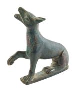 A ROMAN BRONZE MODEL OF A SEATED DOG, CIRCA 1ST-2ND CENTURY A.D.