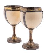 A pair of George III silver-gilt mounted ostrich-egg cups, circular form,