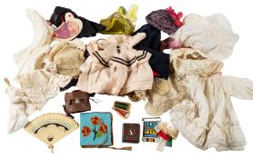 A collection of 19th century and later dolls clothes and accessories together with a miniature