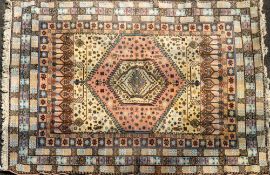 A Persian carpet, later 20th century; with central hexagonal reserves of stylised flower heads,