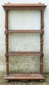 A set of walnut open wall shelves,