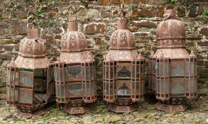 A set of four large metal and glazed mosque lanterns,