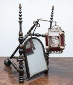 An unusual Regency turned and ebonised wood and lantern mounted table mirror,