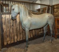 A life-size carved and painted wood model of a pony, early 20th century; dappled grey,