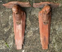 A pair of Indian carved and painted wall brackets modelled as birds of prey,