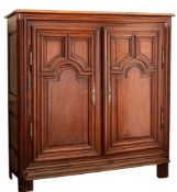 A Louis XV carved oak armoire, second half 18th century; the top with moulded edges,